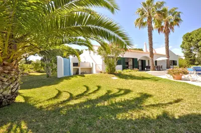 a pool in front of a house with palm trees at Close to Beaches and All Amenities, Private Pool, Free AC and Wifi in Quarteira