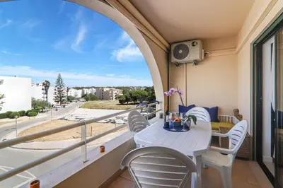 a balcony with a table and chairs and a view of a street at Refugio Salgados in Galé