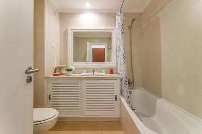 a bathroom with a sink and a mirror and a tub at Refugio Salgados in Galé