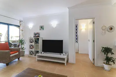 a living room with a flat screen tv and a couch at Refugio Salgados in Galé