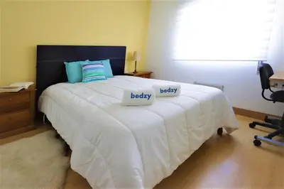 a bedroom with a bed with two pillows on it at Apartamento Palmeira Gale - Beach - Pool - BY BEDZY in Albufeira