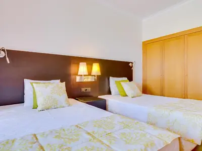 a hotel room with two beds and two lamps at AL - Apartamento Vila Sol F5 AE in Vilamoura
