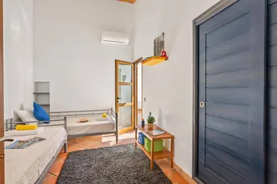 a living room with a blue door and a couch at Villa Casa Tina by Villa Plus in Albufeira