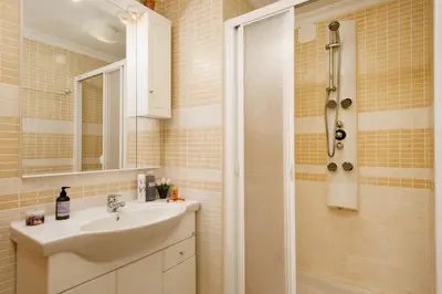 a bathroom with a sink and a shower at Villa Cubos by Villa Plus in Albufeira