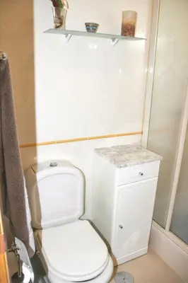 a small bathroom with a toilet and a shelf at Charming Apartment in Vilamoura with Shared Pool - 70 m² in Vilamoura