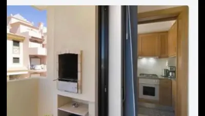 a view of a kitchen through a sliding glass door at Charming Apartment in Vilamoura with Shared Pool - 70 m² in Vilamoura
