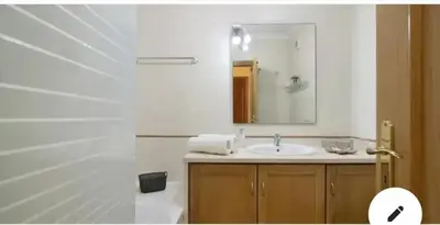 a bathroom with a sink and a mirror at Charming Apartment in Vilamoura with Shared Pool - 70 m² in Vilamoura