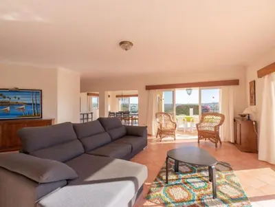 a living room with a couch and a table at Villa Agua - Modern villa, quiet location walkable to restaurant and supermarket in Guia