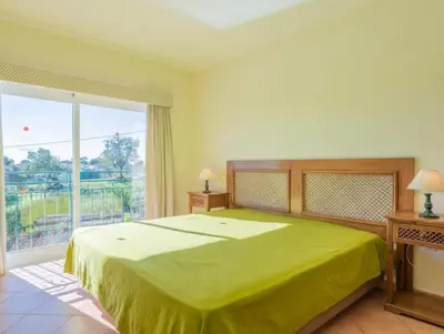 a bedroom with a green bed and a large window at Villa Agua - Modern villa, quiet location walkable to restaurant and supermarket in Guia