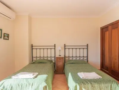 two beds sitting next to each other in a bedroom at Villa Agua - Modern villa, quiet location walkable to restaurant and supermarket in Guia