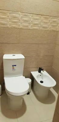a bathroom with a white toilet and a sink at Happy House Comfort Plus in Faro
