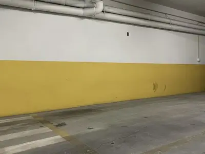 a yellow and white wall in a parking garage at Miral 1 - Apartment 100m to the beach by HD PROPERTIES - Quarteira in Quarteira