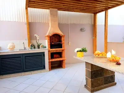 a kitchen with a wood fired oven in the middle at Miral 1 - Apartment 100m to the beach by HD PROPERTIES - Quarteira in Quarteira