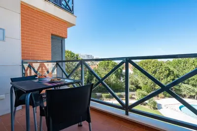 a balcony with a table and chairs and a view at Corcovada in Albufeira