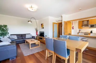 a living room with a table and a couch at Corcovada in Albufeira