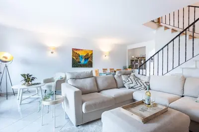 a living room with a couch and a table at Casa Primavera in Albufeira