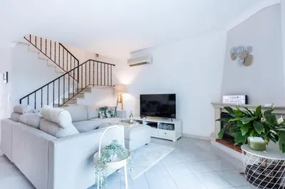 a living room with a couch and a tv at Casa Primavera in Albufeira