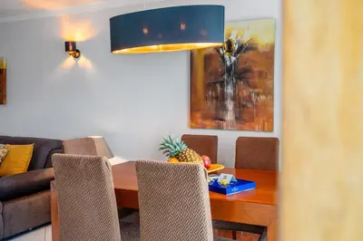 a dining room with a table and a couch at Duplex Sea View by Albufeira Holidays in Albufeira