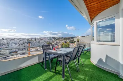 a table and chairs on a balcony with a view at Duplex Sea View by Albufeira Holidays in Albufeira