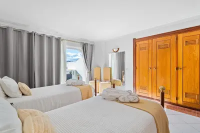 a hotel room with two beds and a window at Duplex Sea View by Albufeira Holidays in Albufeira