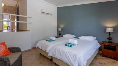 a bedroom with a bed with two pillows on it at Victory Village Quinta do Lago - Spacious 2 Bed / 3 Bath Apartment in Almancil