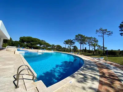 a large swimming pool with a clear blue at Victory Village Quinta do Lago - Spacious 2 Bed / 3 Bath Apartment in Almancil