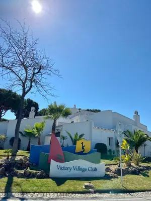 a sign for victory village club in front of a building at Victory Village Quinta do Lago - Spacious 2 Bed / 3 Bath Apartment in Almancil