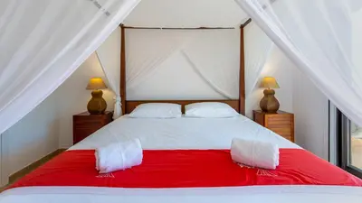 a bedroom with a red and white bed with two lamps at Victory Village Quinta do Lago - Spacious 2 Bed / 3 Bath Apartment in Almancil