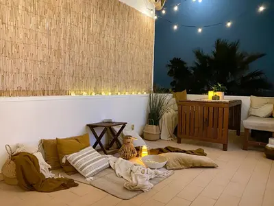 a living room with a couch and a table at Beach villa with ocean view and rooftop cinema in Guia