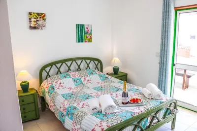 a bedroom with a bed with a tray of food on it at Apartamento Jardim de Sta Eulália in Albufeira