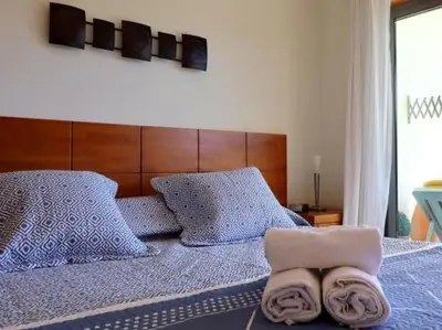 a bedroom with a bed with two towels on it at Happiness Apartment by Stay ici Algarve Holiday Rental in Albufeira