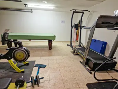 a room with a gym with a treadmill and weights at Qta do Eucalipto Villa in Faro