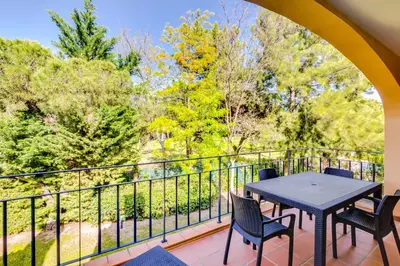 a patio with a table and chairs on a balcony at AL - Apartamento Vila Sol F5 D in Vilamoura