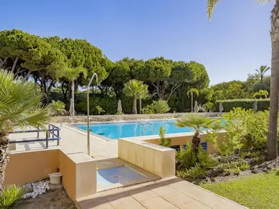a swimming pool in a yard with trees at AL - Apartamento Vila Sol F5 D in Vilamoura