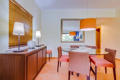 a dining room with a table and chairs at AL - Apartamento Vila Sol F5 D in Vilamoura