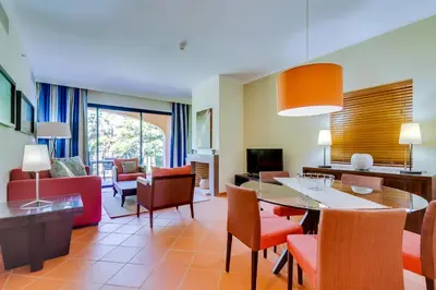 a living room with a dining table and chairs at AL - Apartamento Vila Sol F5 D in Vilamoura