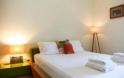 a bedroom with a bed with towels on it at Villa a Sul in Albufeira