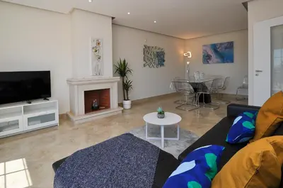 a living room with a couch and a fireplace at Oura Sea View by OCvillas in Albufeira