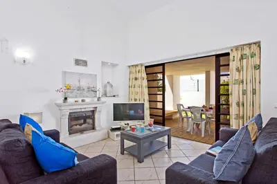 a living room with two couches and a fireplace at Villa Neptuno Sol by Villa Plus in Albufeira