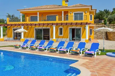a villa with a swimming pool in front of a house at Villa Ribeiro Tomas by Villa Plus in Loulé