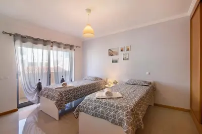 a bedroom with two beds and a window at Apartamento Água Brisa in Albufeira