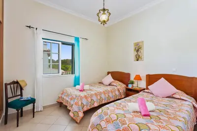 a bedroom with two beds and a window at Villa Arvela by Villa Plus in Galé