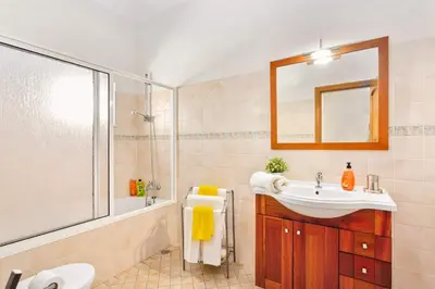 a bathroom with a sink and a shower and a mirror at Villa Arvela by Villa Plus in Galé