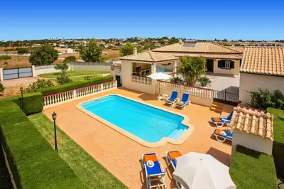a swimming pool in the backyard of a house at Villa Arvela by Villa Plus in Galé