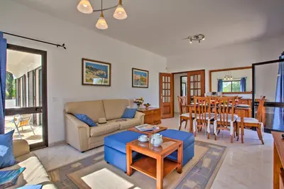 a living room with a couch and a table at Villa Candida by Villa Plus in Vale do Lobo
