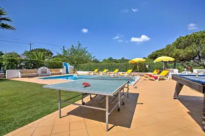 a ping pong table and pool tables in a yard at Villa Candida by Villa Plus in Vale do Lobo