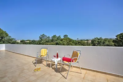 three chairs and a table on a balcony at Villa Candida by Villa Plus in Vale do Lobo