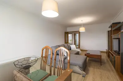 a living room with a couch and a table at Miral 2 - Beach front apartment with pool in Quarteira