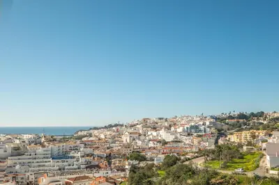 a hotel room with a bed and a mirror at #018 T2 Elisabete by Home Holidays in Albufeira