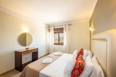 a bedroom with a large bed and a glass window at #018 T2 Elisabete by Home Holidays in Albufeira